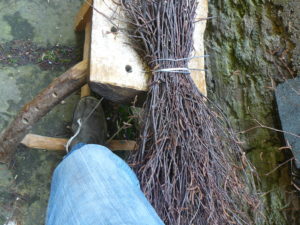 Twigs held in rope sling