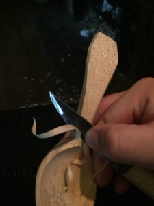 knife slicing a bevel toward the bowl